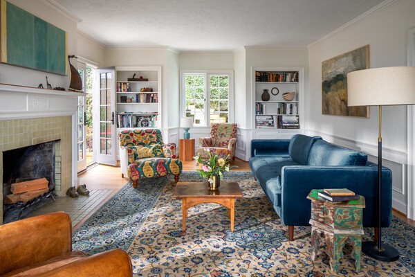 A functional wood-burning fireplace warms the living room.