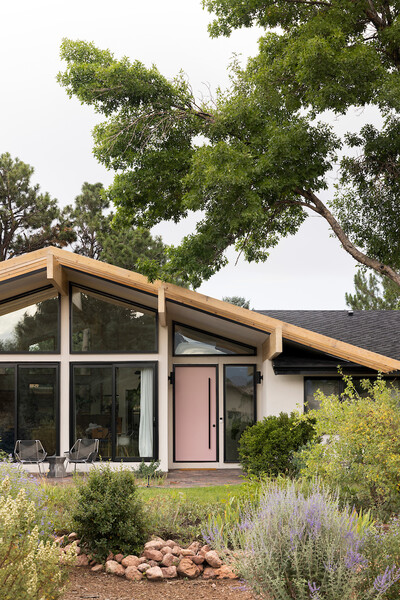 The designers introduced new Alaskan yellow cedar glulam beams for the updated roofline and windows by Pella. The front door is painted in Sherwin Williams "Rose Colored."