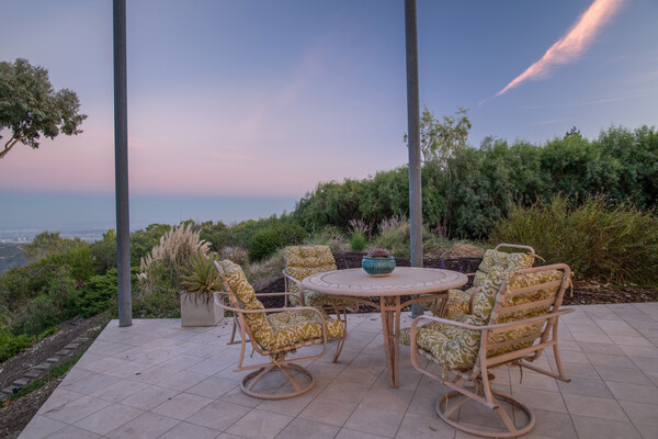 The dining room continues outdoors to a shaded terrace for even more entertainment area.