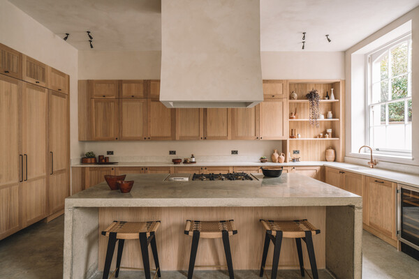 The ground floor material palette features polished concrete floors and lime washed walls.