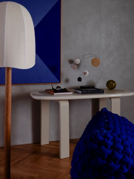 The table beneath the Kaspar Raglus painting is the Orbit console by Faye Toogood for Tacchini.