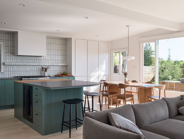 A view into the open living space, where the large windows allow for abundant natural light.