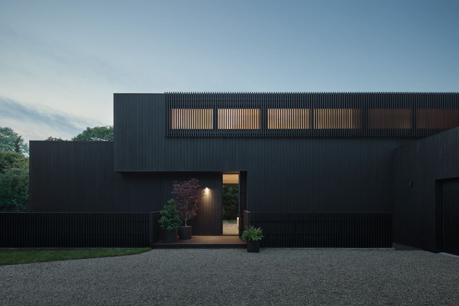 After entering through a gate, the home's charred spruce siding presents a somber face.