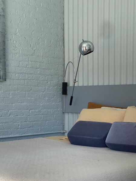 Antonio inherited one of the 1960s chrome Orbit sconces by Robert Sonneman and bought the other at Home Union in Brooklyn.