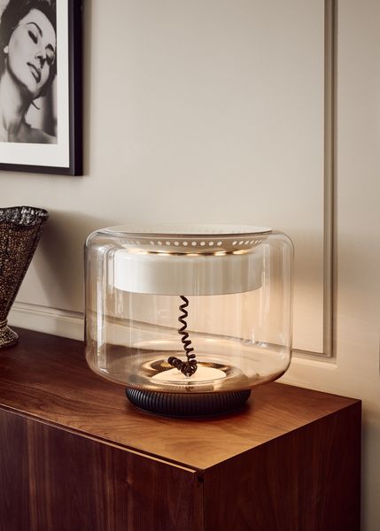 Based on a Gianfranco Frattini design from 1961, the Memoria lamp remains an eyecatching piece today with its visible telephone-style cord and glass shade.