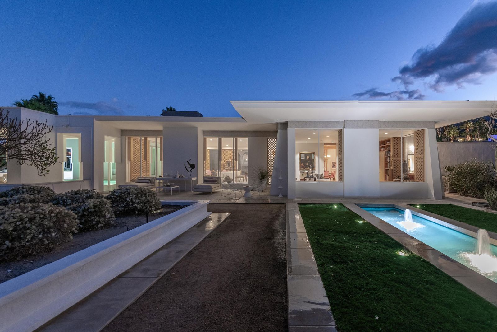 Designed by Eggers & Wilkman, this 1958 Rancho Mirage home has Carrara marble floors, decorative wood screens, and a courtyard with a fountain.