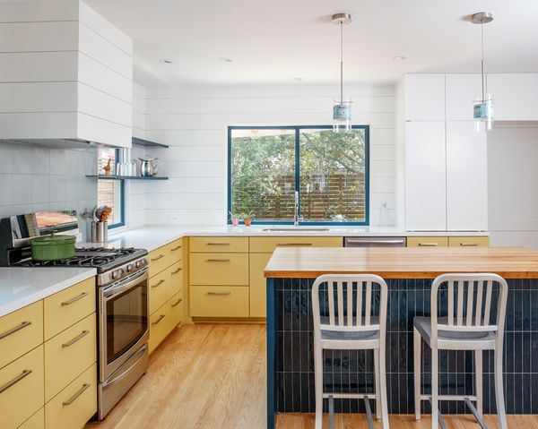 During the renovation, they discovered a window on the north side of the kitchen and built some shelving in front of it to enjoy storage while still letting the light in. 