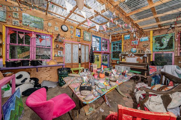 In addition to the main house, the property includes a green house and two smaller cabins.