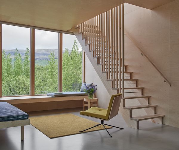 In the living room, an Artek daybed is covered in Helios dark green fabric from Johanna Gullichsen.