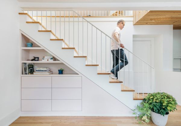 Storage is built in wherever possible throughout the home—including in this nook underneath the stairs—allowing the family to optimize the space