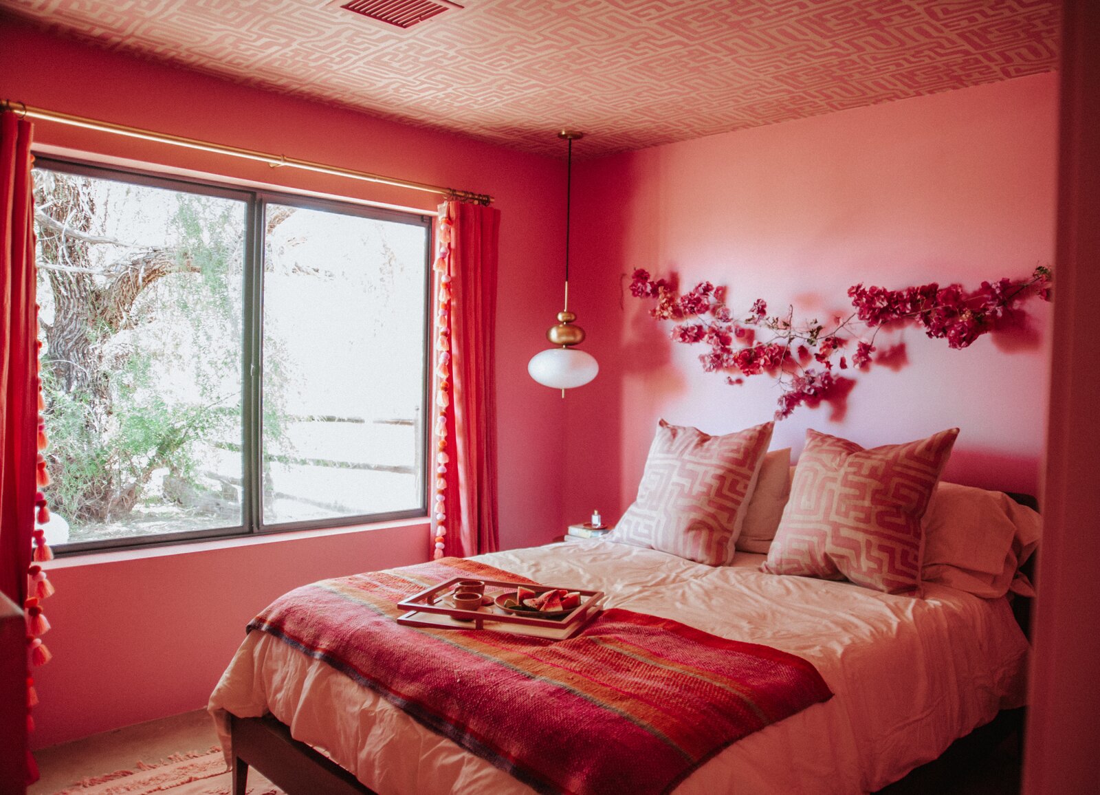 Textiles from St. Frank accent the all-pink guest room.