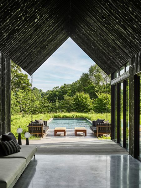 Upon entry, the view expands to highlight the pool, wildflower meadow, and surrounding vegetation.